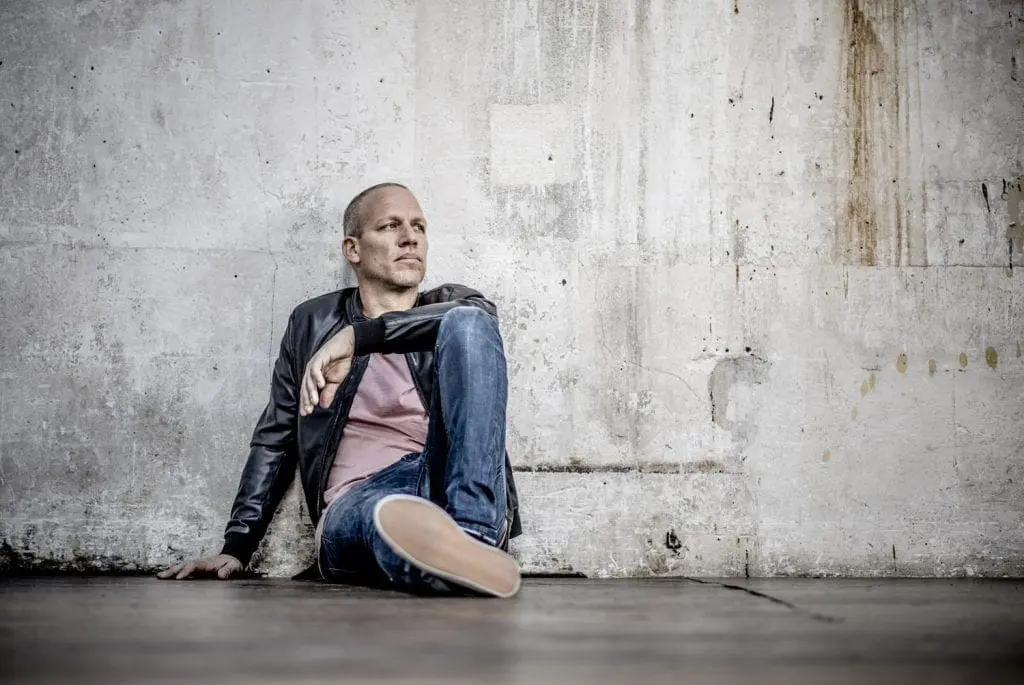'1970' promotional photo of Avishai Cohen sitting in the street