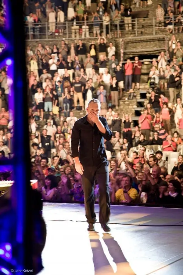 Avishai Cohen on stage with audience behind