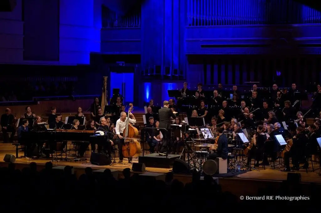 Avishai Cohen playing with orchestra on stage