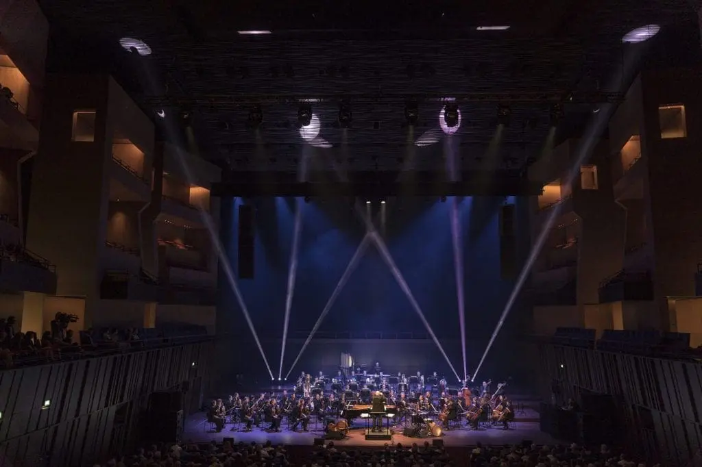 Avishai Cohen with orchestra on stage