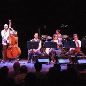 Avishai Cohen with musicians on stage