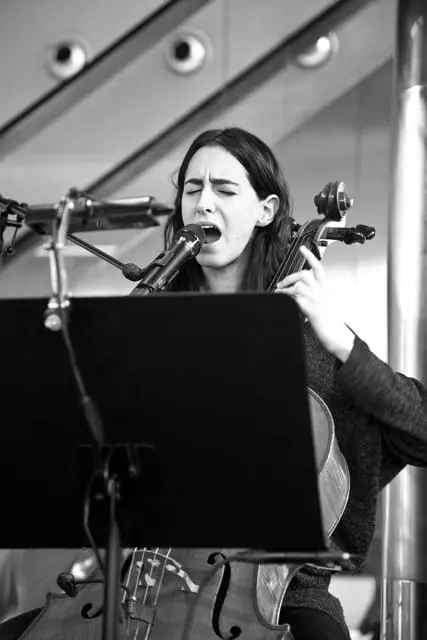 musician playing cello and singing